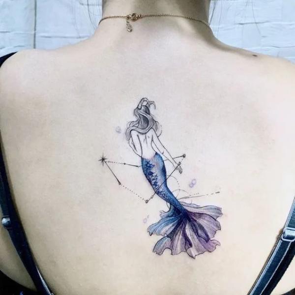 Small feminine Capricorn Sea goat back tattoo