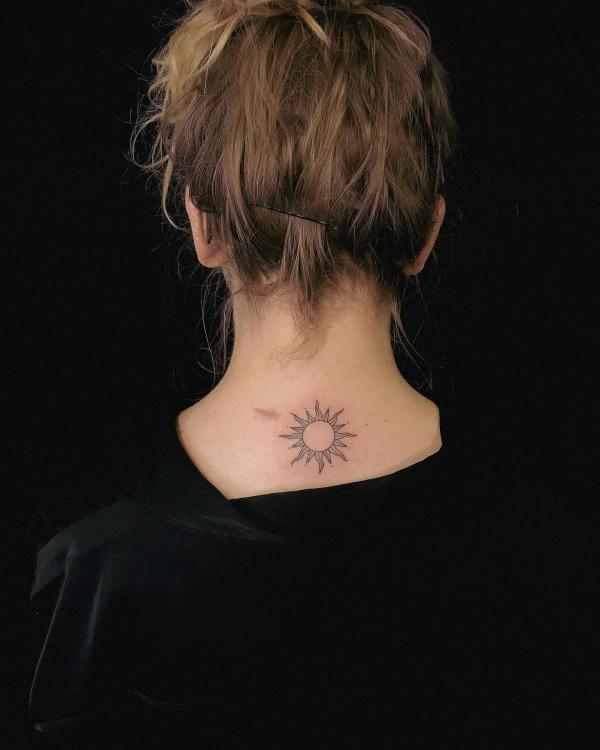 Small sun nape tattoo
