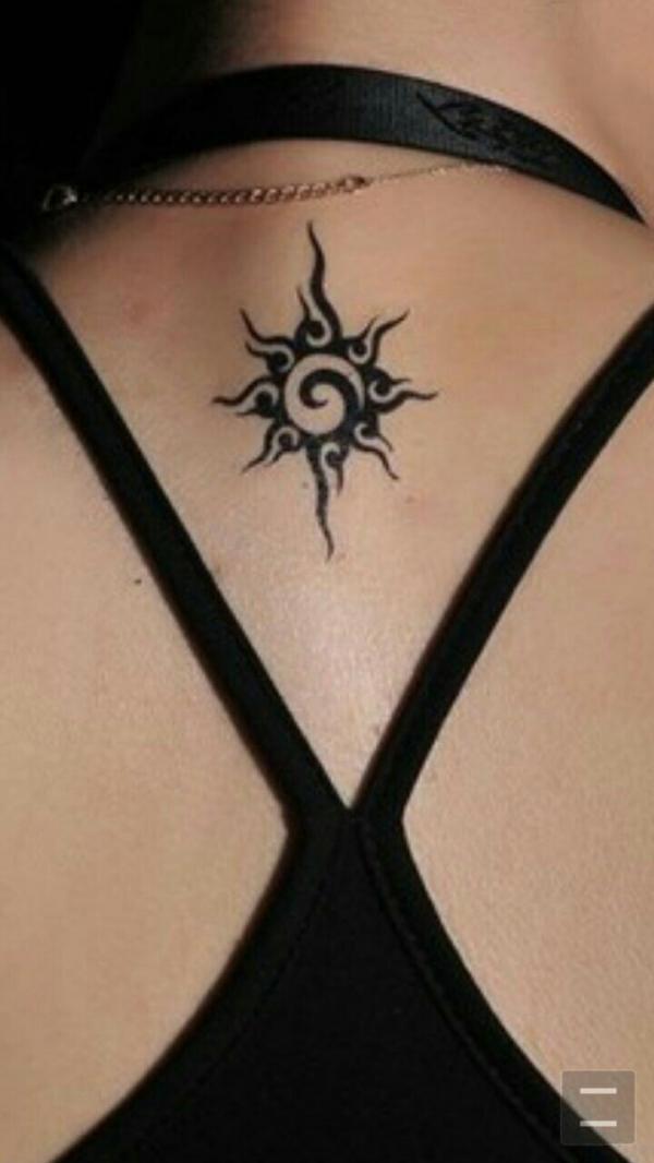 Small tribal sun back tattoo for female