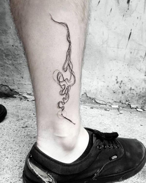Smoke above ankle tattoo