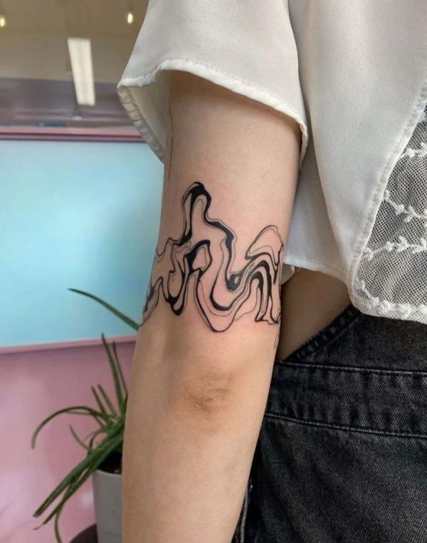 Smoke above elbow tattoo