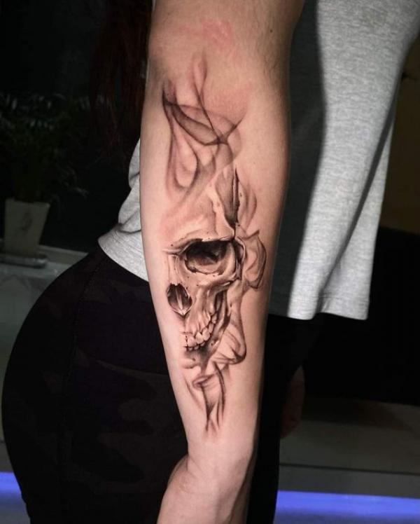 Smoke and half skull tattoo