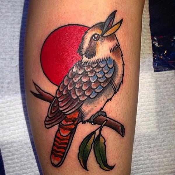 Sun and a bird perched on branch tattoo