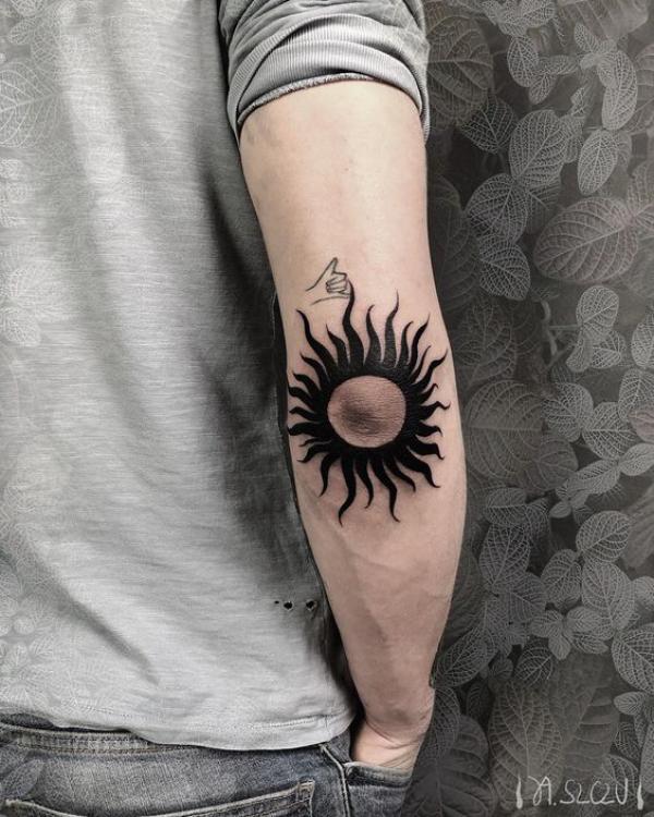 Sun elbow tattoo
