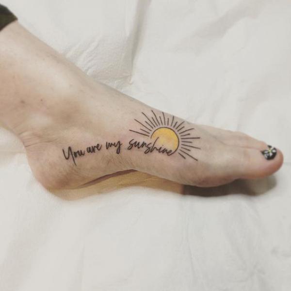 Sun foot tattoo with words You are my sunshine