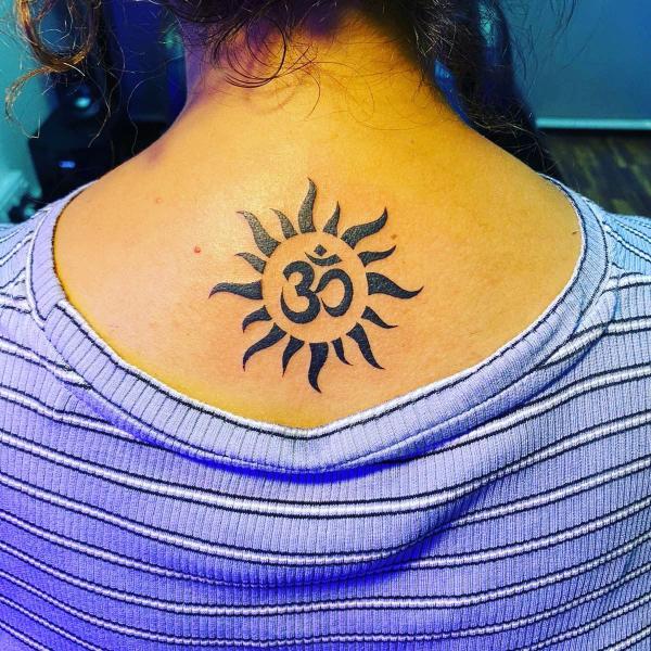 Sun with OM symbol tattoo on upper back