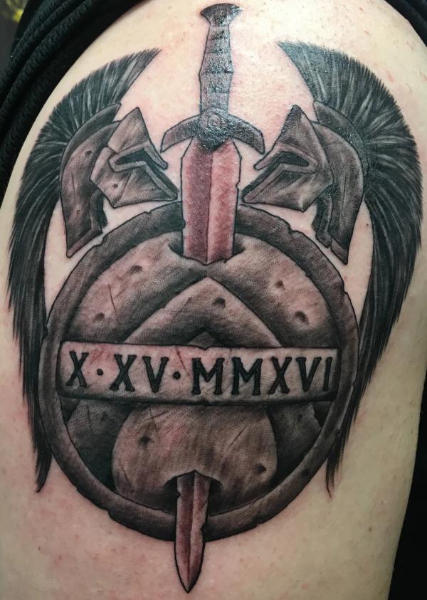 Sword shield with Roman Numerals tattoo ahoulder