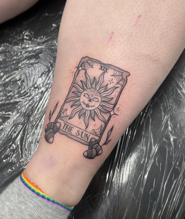 The Sun card tattoo black and grey