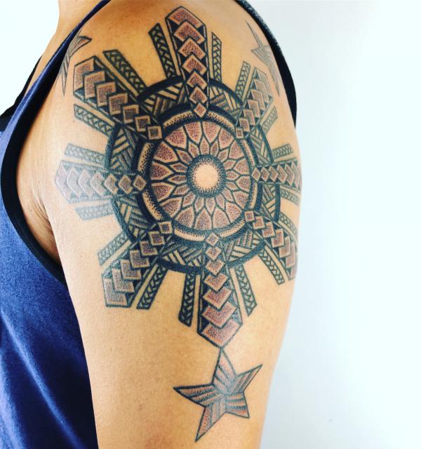Tribal filipino sun with three stars tattoo