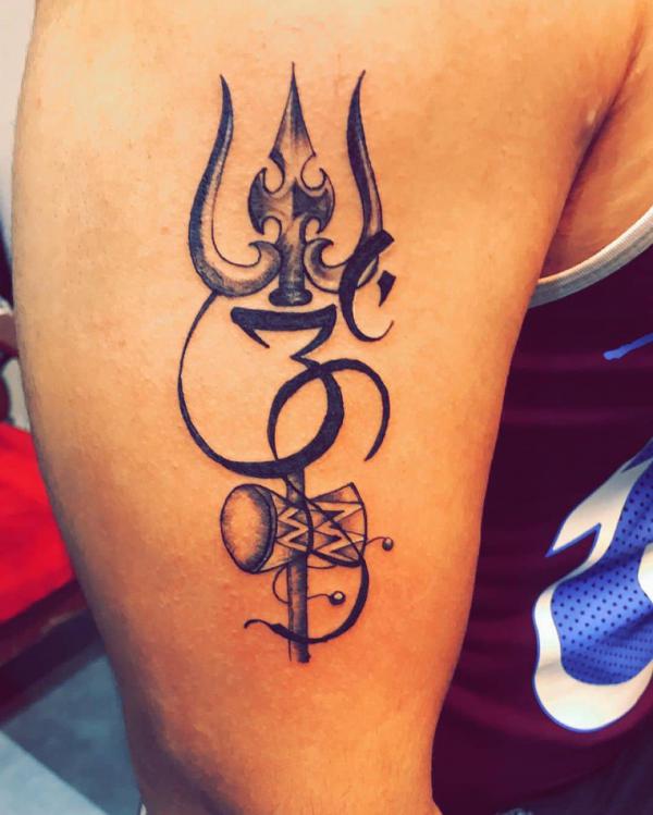 Trishul with damaru upper arm tattoo