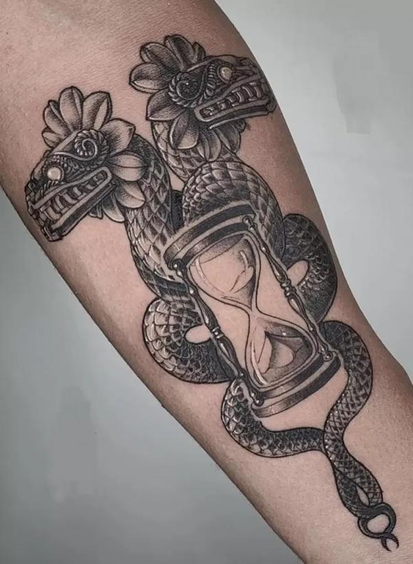 Two Quetzalcoatl and hourglass tattoo