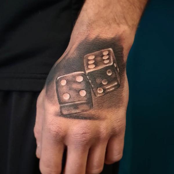 Two dices hand tattoo