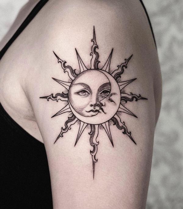 Upper arm sun and moon tattoo