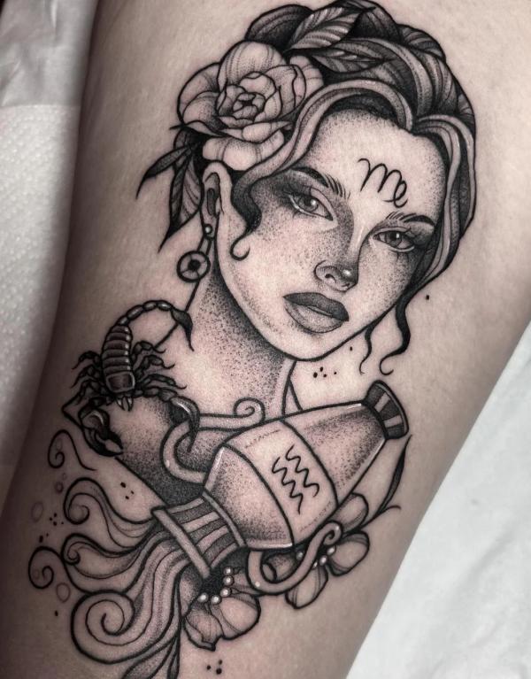 Virgo woman with scorpion holding Aquarius water bearer tattoo