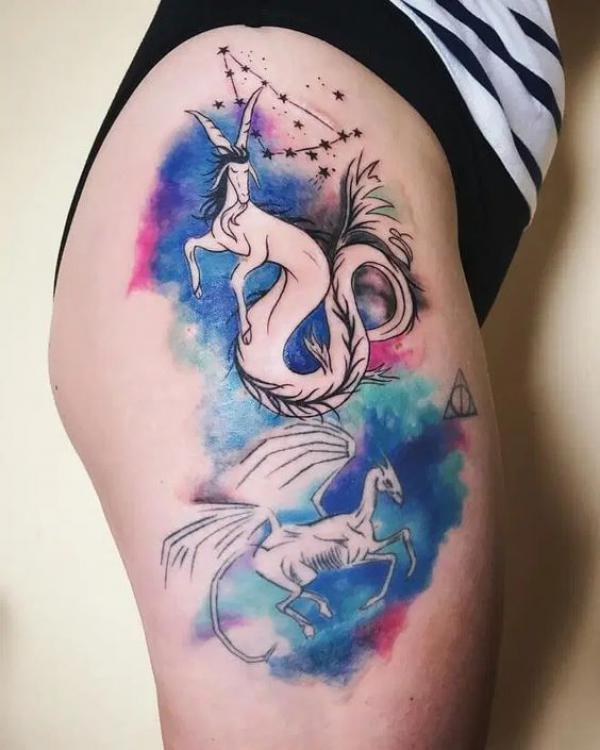 Watercolor Capricorn sea goat and thestral tattoo thigh