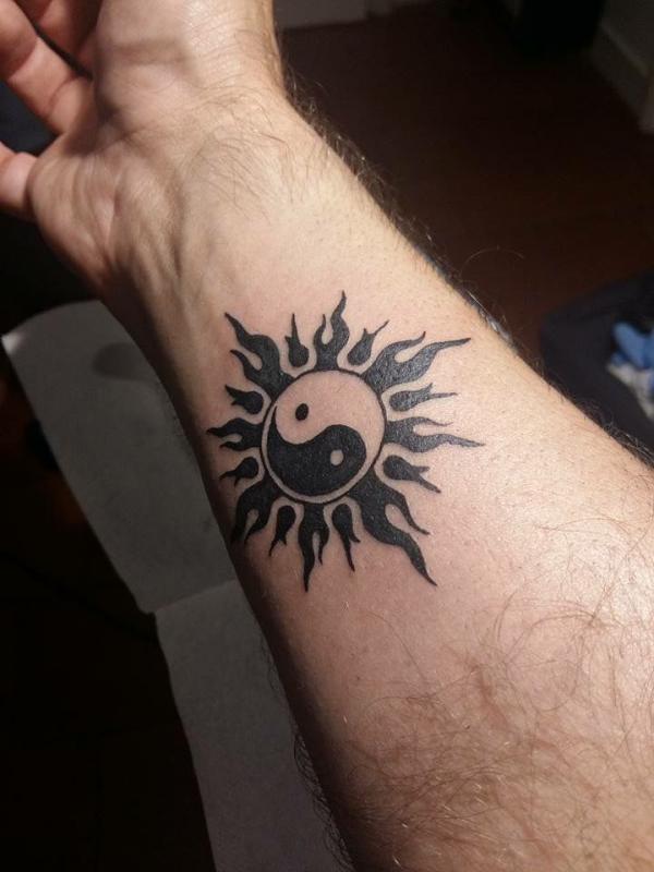 Yin Yang sun tattoo on inner forearm for men