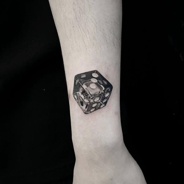 blackwork dice wrist tattoo