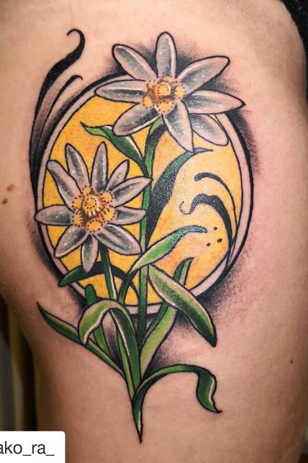 edelweiss flowers and yellow sun tattoo