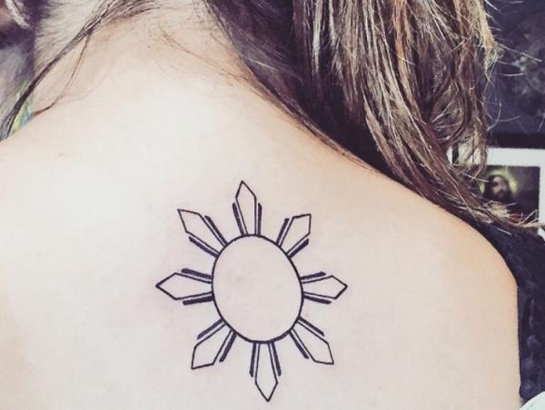 filipino sun upper back tattoo