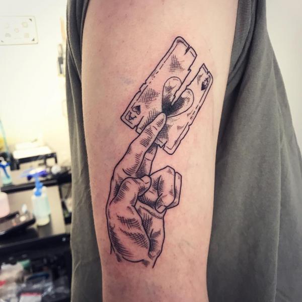 fingers holding broken Ace of spade tattoo