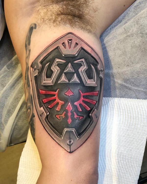 hylian shield bicep tattoo
