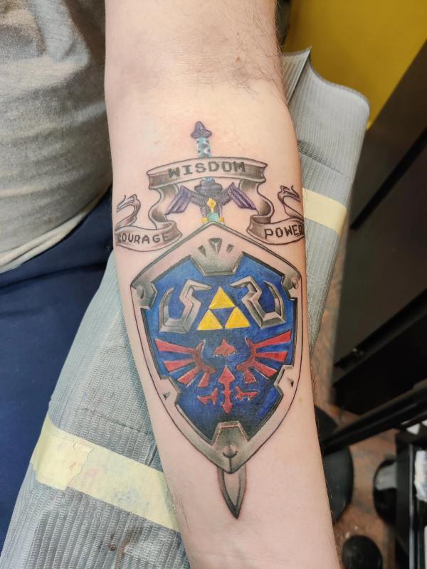 hylian shield tattoo forearm