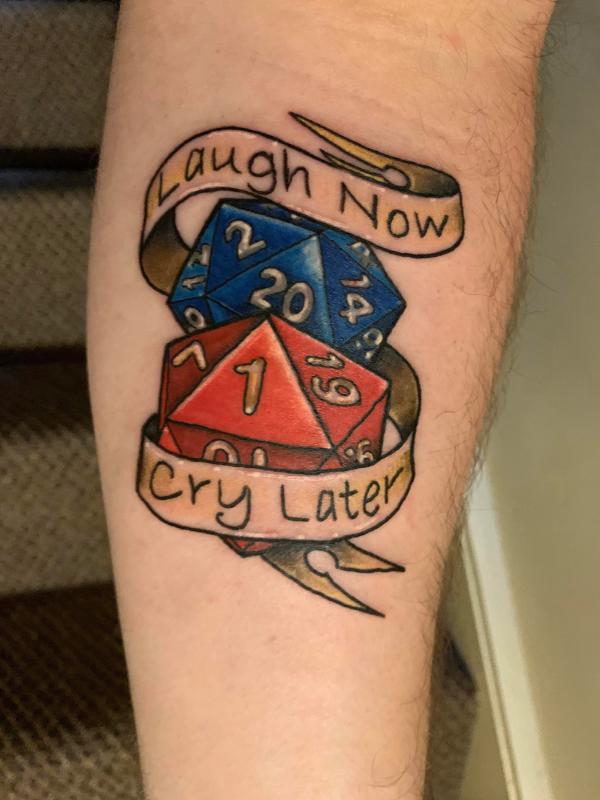 icosahedron dices with ribbon bearing words laugh now cry later