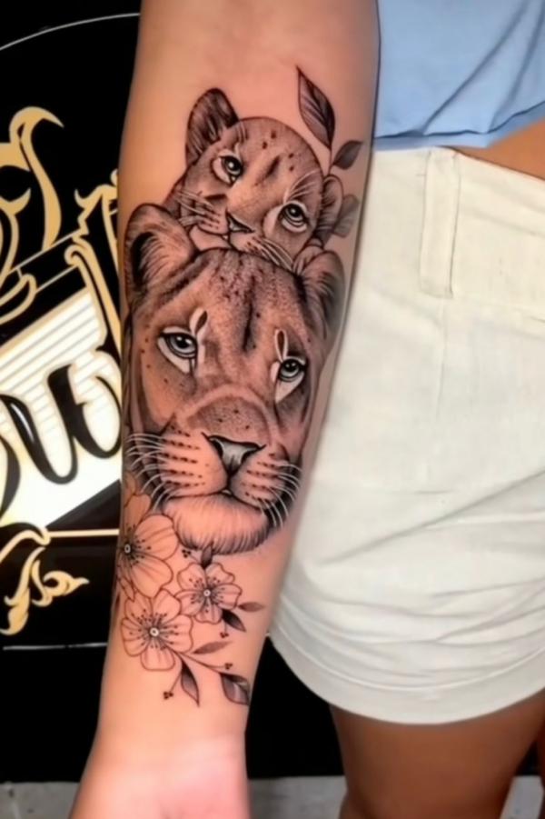 lioness and cub heads tattoo forearm