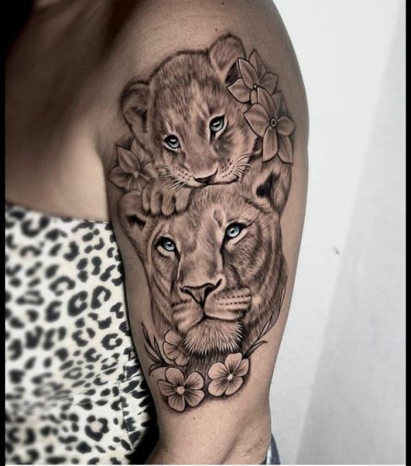 lioness and cub with flowers tattoo half sleeve