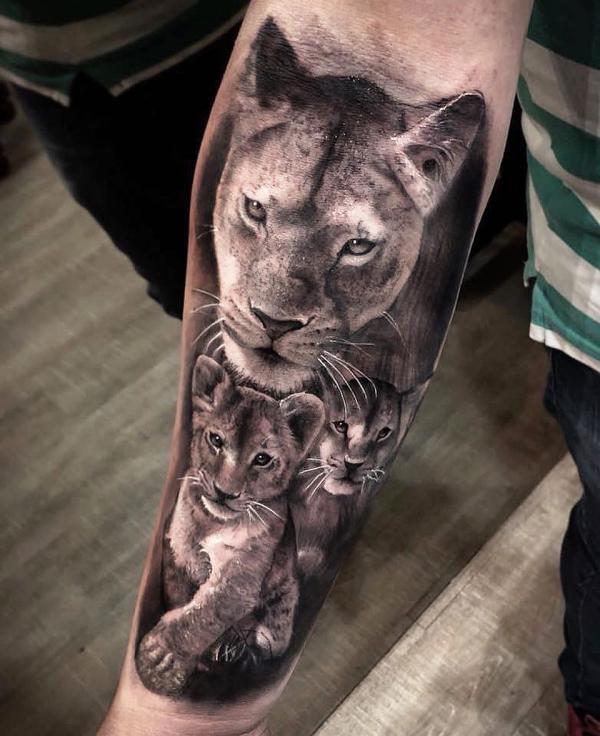 lioness and two cubs tattoo forearm