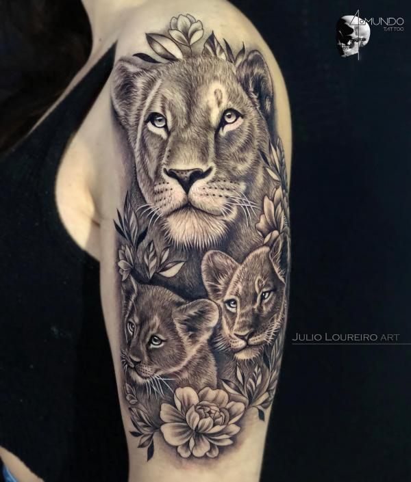 lioness and two cubs with flowers tattoo half sleeve