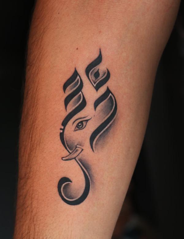 om and ganesh tattoo forearm