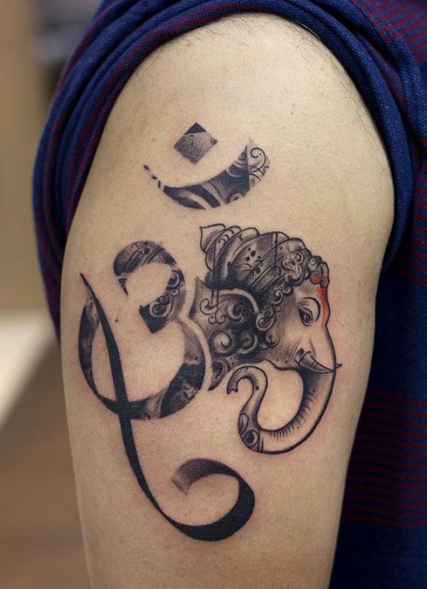 om and ganesh tattoo upper arm