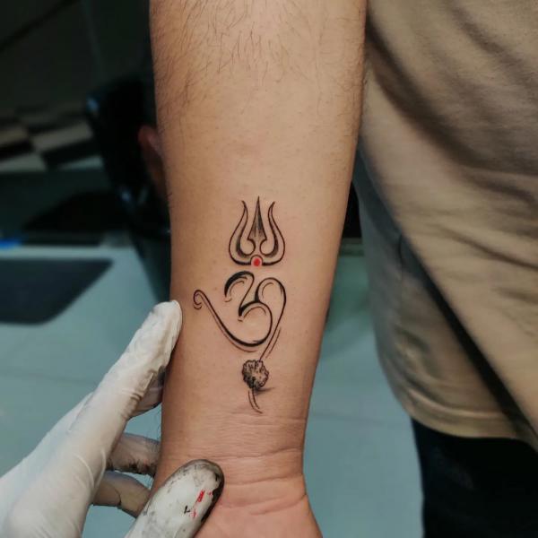 om and trishul tattoo forearm