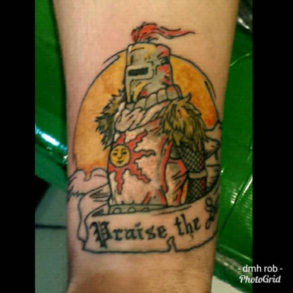 praise the sun tattoo on arm