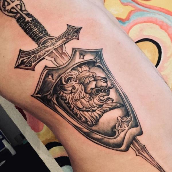 sword shield with lion tattoo