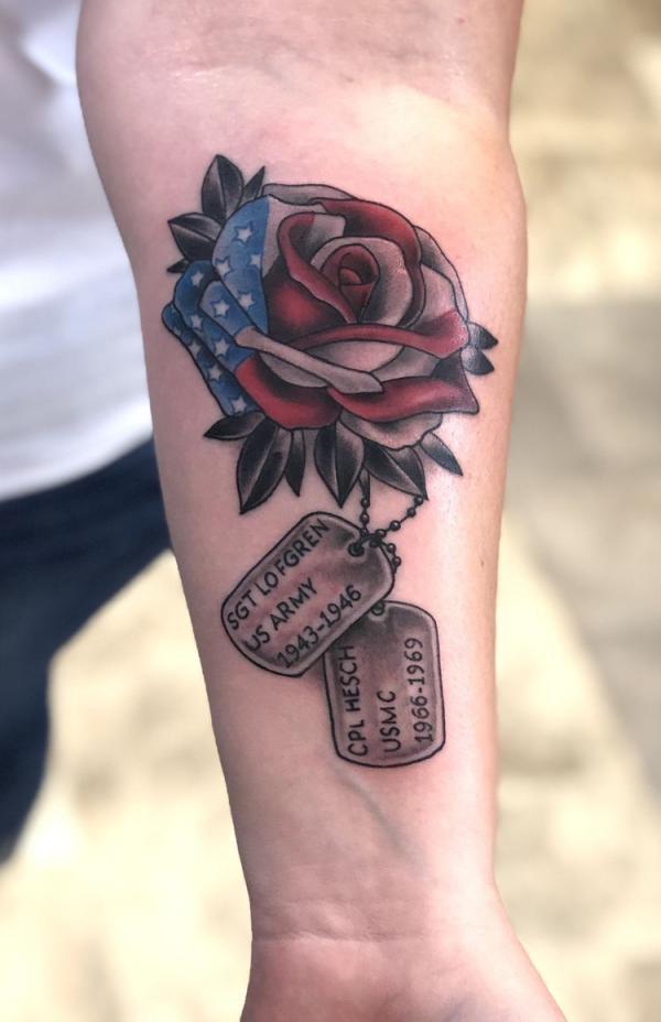 American flag rose with dog tag tattoo forearm