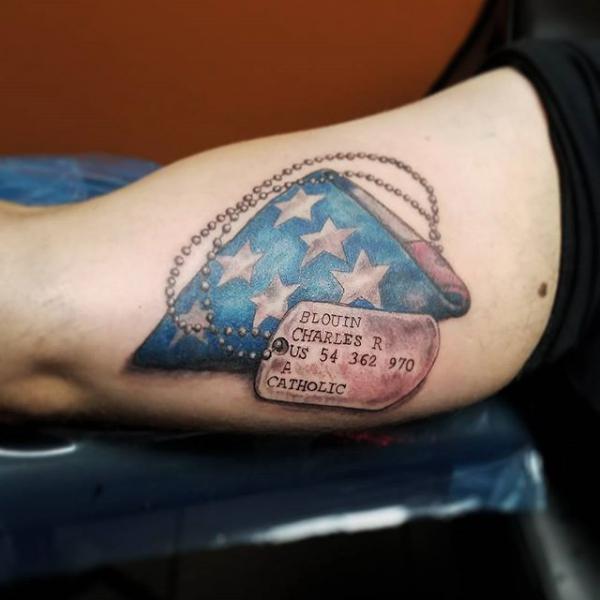Amrican flag and dog tag bicep tattoo