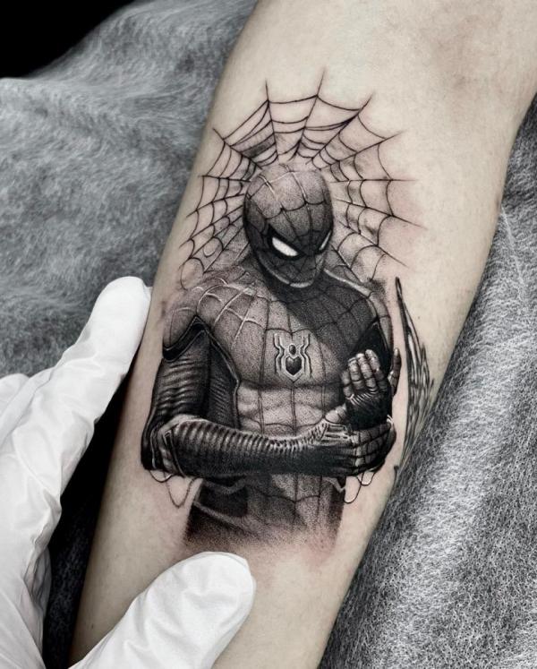 Black and grey Spider Man tattoo on forearm