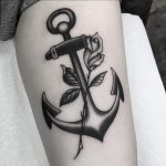 Black and white anchor with a rose tattoo