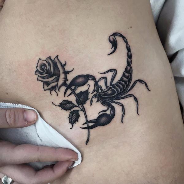 Black and white rose and scorpion tattoo