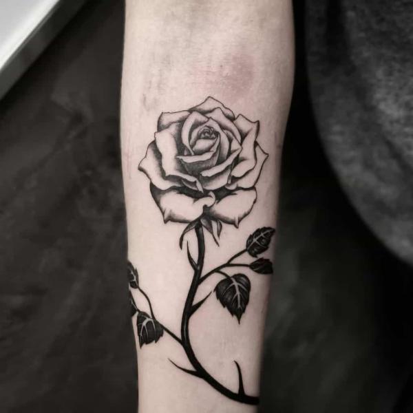 Black and white rose tattoo with thorns