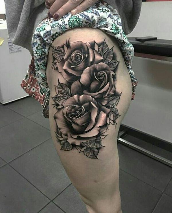 Black and white rose thigh tattoo