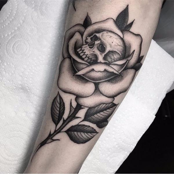 Black and white rose with a skull tattoo
