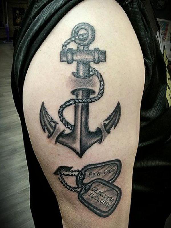 Blackwork anchor and dog tag tattoo