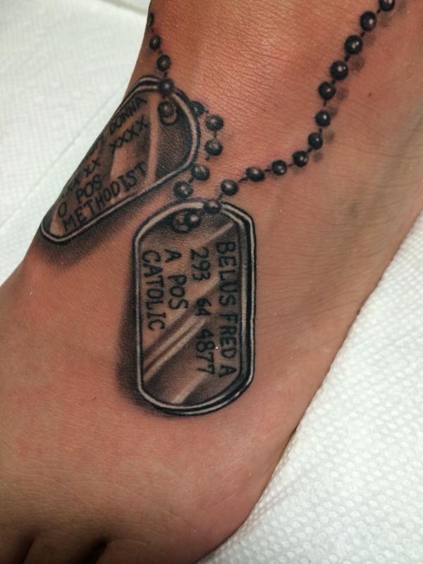 Blackwork dog tag foot tattoo