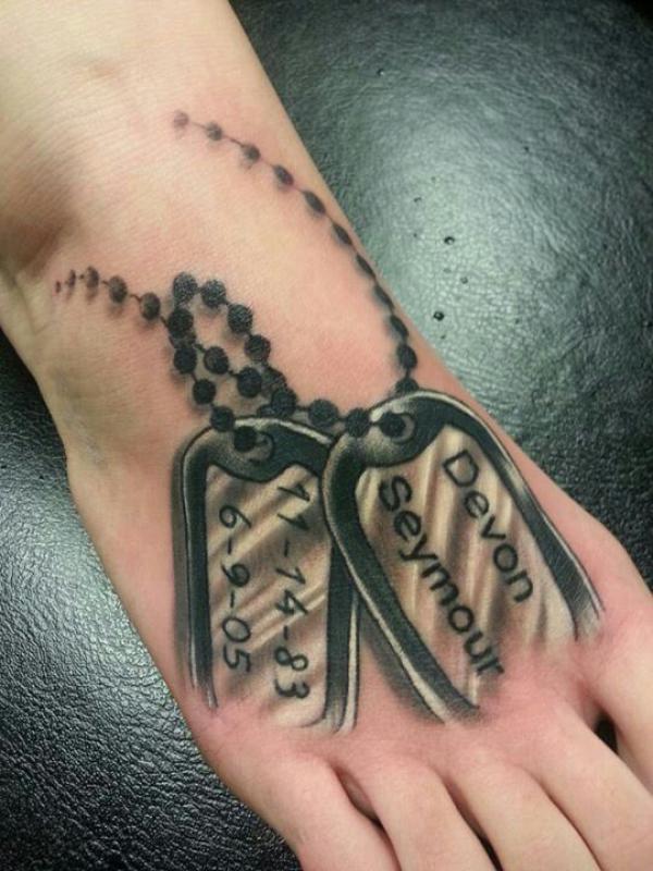 Blackwork dog tag tattoo foot