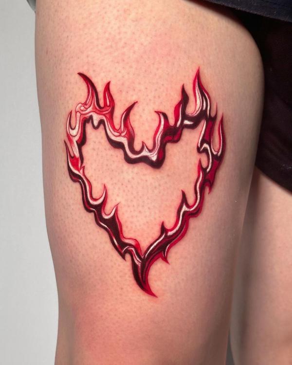 Bold heart with flame outline tattoo
