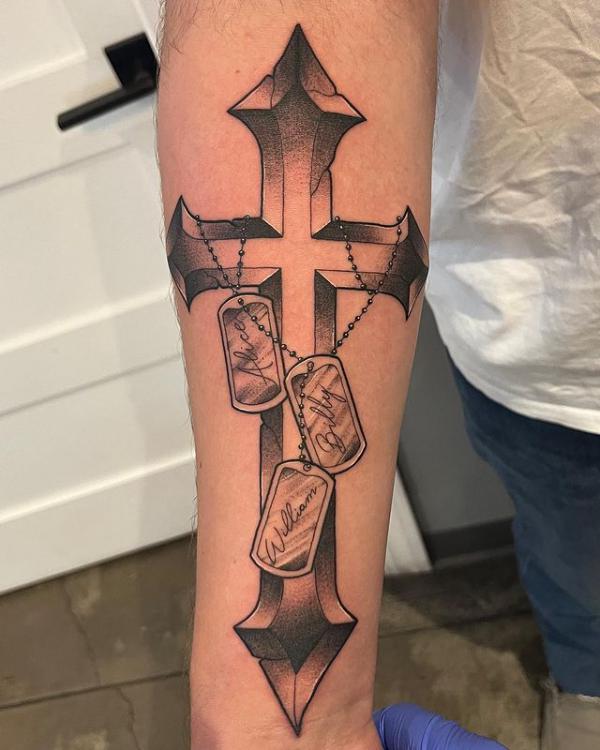 Cross and dog tag tattoo forearm