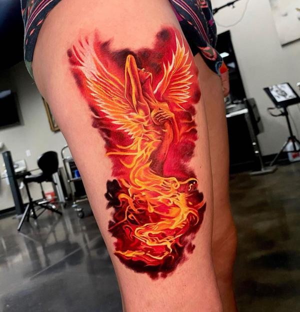 Fire and angel tattoo on thigh